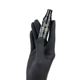 PhiAcademy Skin Candy After Care Balm — aftercare balm bottle held in a gloved hand