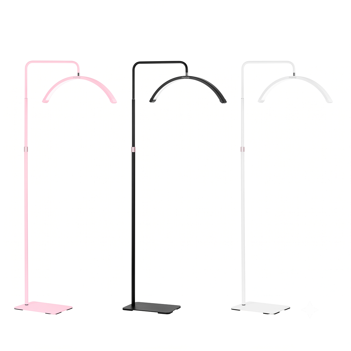 Three modern floor lamps with curved overhead arms and flat square bases, shown in pink, black, and white