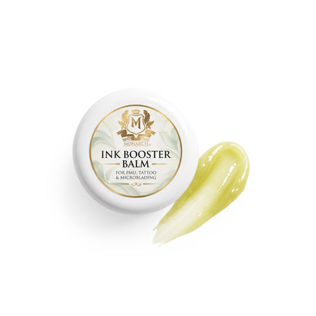 Skin Monarch Ink Booster Balm 30ml, wieczko obok smugi błyszczącego żółtego balsamu